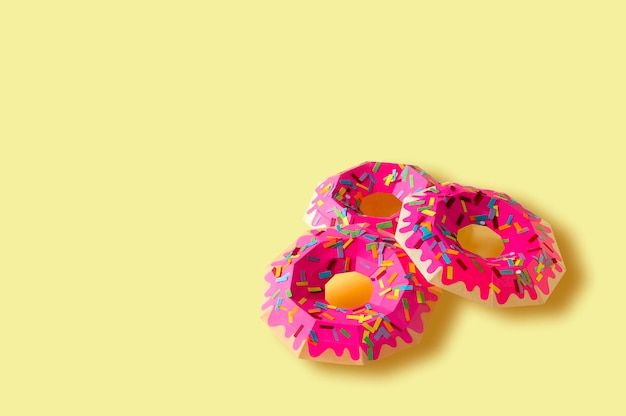Donuts de papel sobre fondo amarillo