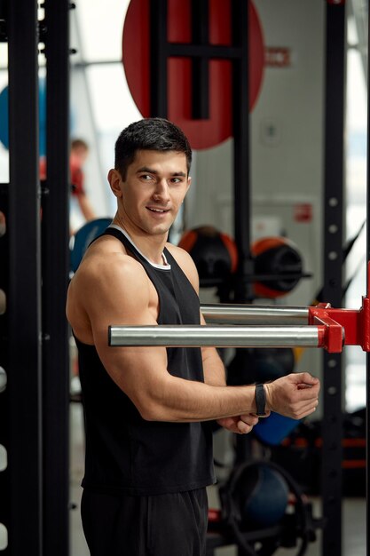 Dor durante o trabalho de exercício com seu próprio peso o atleta faz exercícios nas barras assimétricas superando a dor