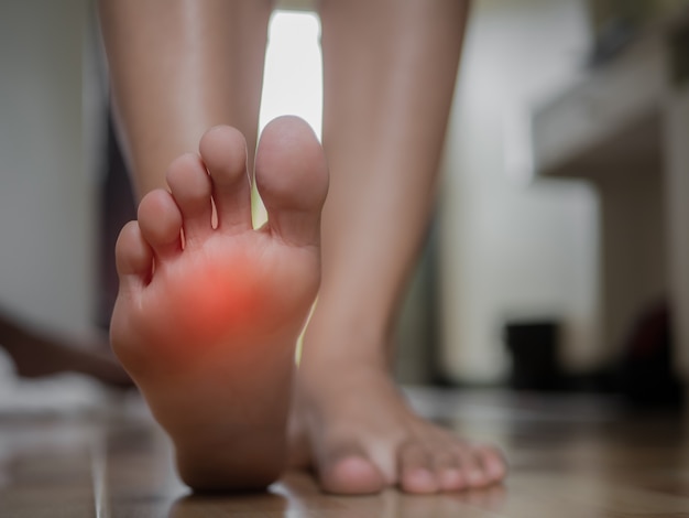 Foto dor fêmea do pé do close up, conceito dos cuidados médicos.