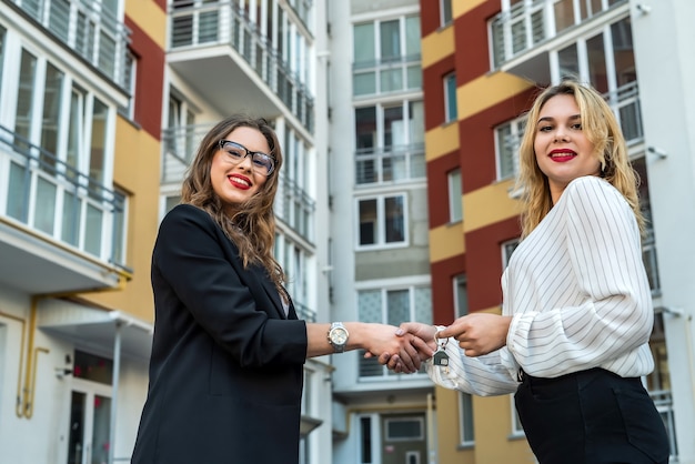 Dos agentes inmobiliarios mostrando casa para la venta o alquiler