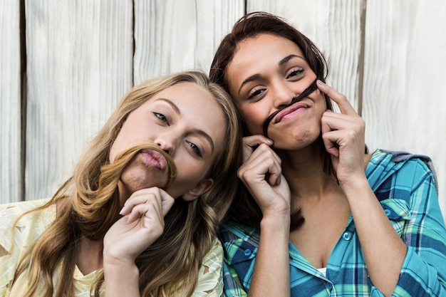 Dos amigas divirtiéndose con su pelo.