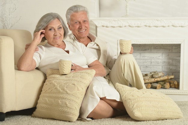 Dos ancianos sentados en casa en el sofá