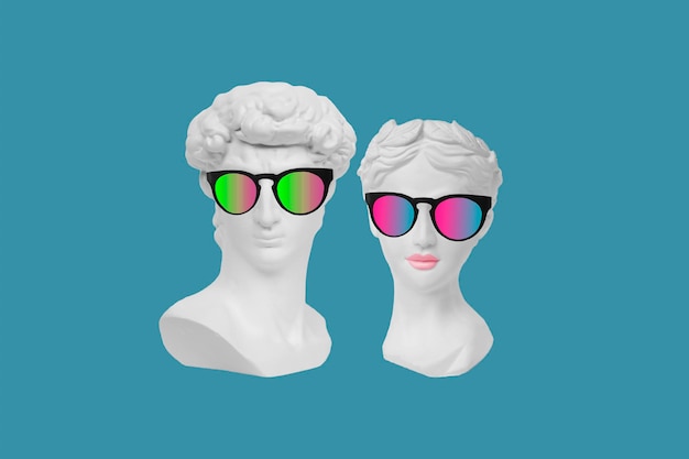 Dos cabezas de estatuas antiguas con elegantes gafas de sol aisladas en un fondo de color azul Hombre y mujer