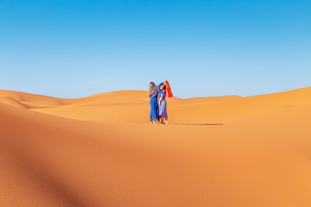 Dos chicas con pañuelos en el desierto del Sahara.