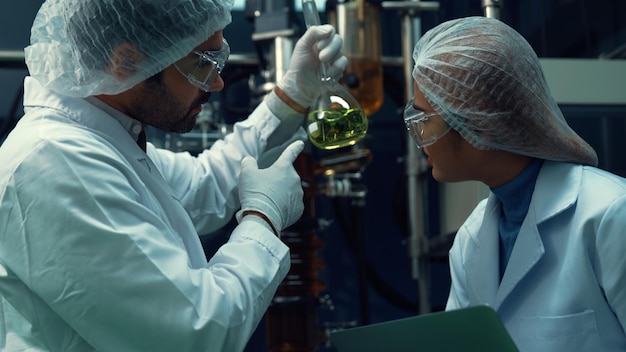 Dos científicos con uniforme profesional trabajando en laboratorio