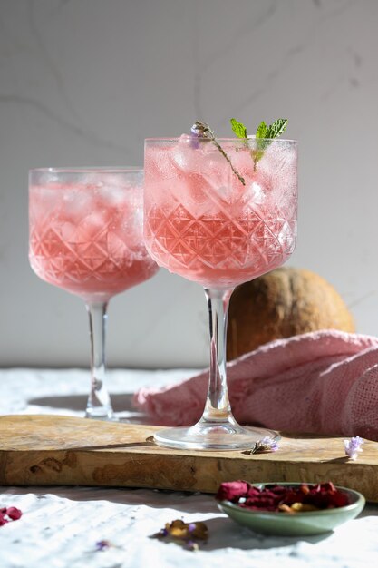 dos cócteles de rosas heladas con coco de menta verde y utilería de madera