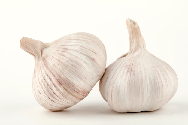 Dos dientes de ajo crudos aislado sobre fondo blanco.