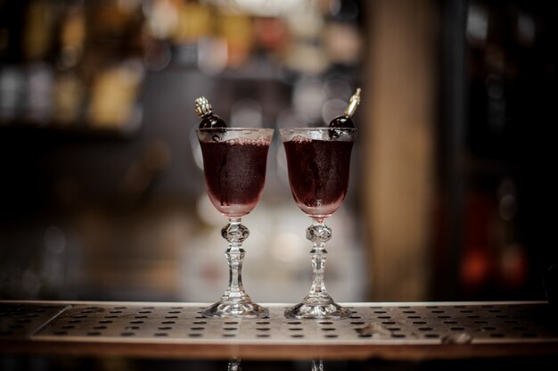 Dos elegantes vasos llenos de dulce y fuerte cóctel de verano Arnaud