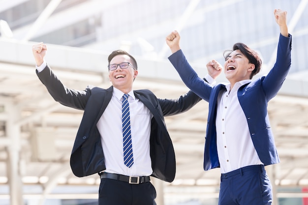 Dos empresarios asiáticos felices están trabajando en la ciudad