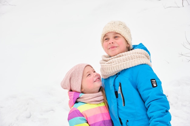 Dos hermanas juegan lindas afuera en un día de invierno