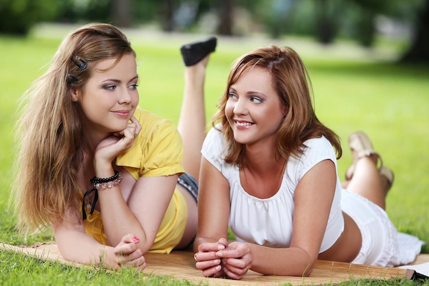 Dos hermosas chicas colgando en el parque