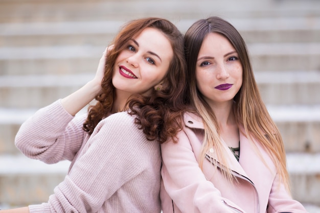 Dos hermosas chicas jóvenes posando en la calle