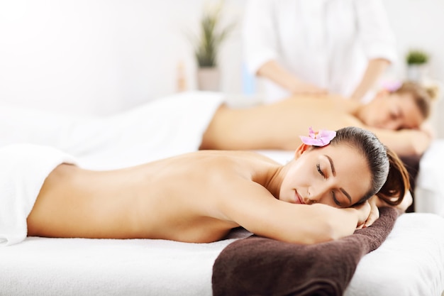 dos hermosas mujeres recibiendo masajes en el spa