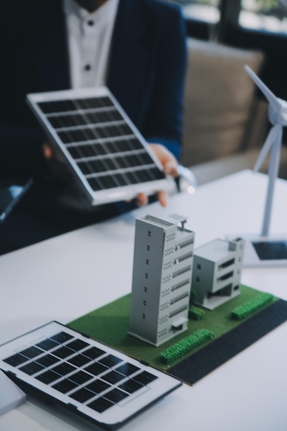 Dos jóvenes ingenieros expertos en la instalación de celdas solares Reuniones y discusión en el trabajo Planificación para instalar paneles solares fotovoltaicos en el techo de la sala de oficinas con plan de construcción de la fábrica