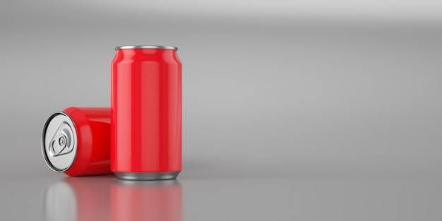 Foto dos latas de cola roja brillante sobre metal