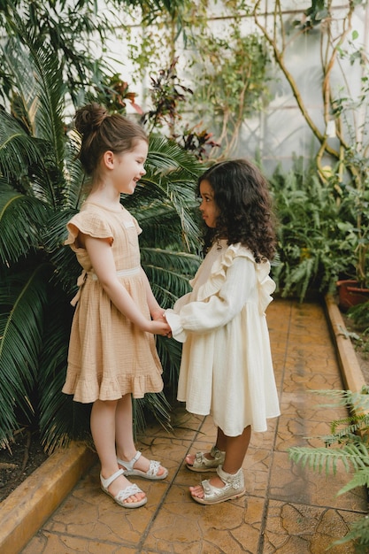 Dos niñas alegres en el jardín botánico primavera verano