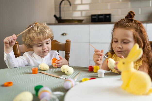 Dos niños decoran huevos para Pascua