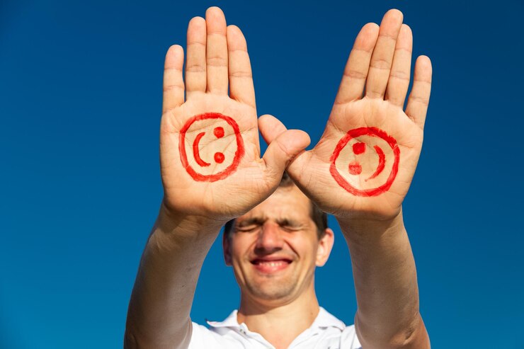 Foto dos palmas masculinas con rostro sonriente pintado de rojo en el fondo del cielo azul concepto del día mundial de la sonrisa