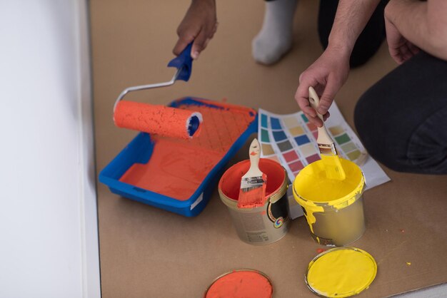 dos pintores preparan el color para pintar la pared