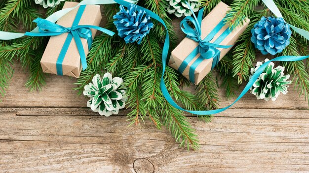 Dos regalos de Navidad en una mesa de madera con oropel.