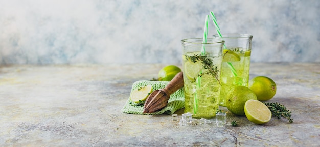 Dos vasos de limonada de lima con tomillo y hielo