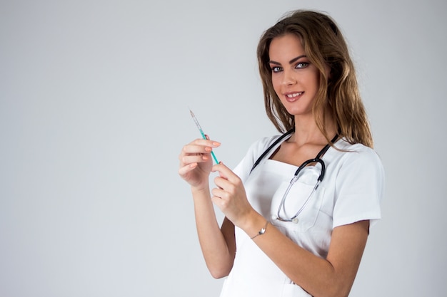 Doutor mulher com seringa isolado no branco, enfermeira com agulha