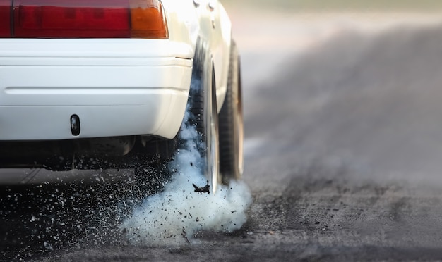 Drag-Rennwagen brennt in Vorbereitung auf das Rennen Gummi von den Reifen