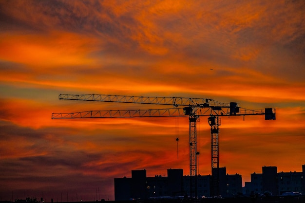 Foto dramático natural con nubes colorido puesta de sol urbana con grúa de construcción