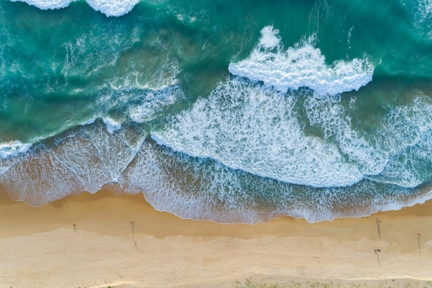 Draufsicht auf die Meerestexturwellen Schäumen und Spritzen am Strand Schöne Welle Meeresoberfläche Hintergrund.