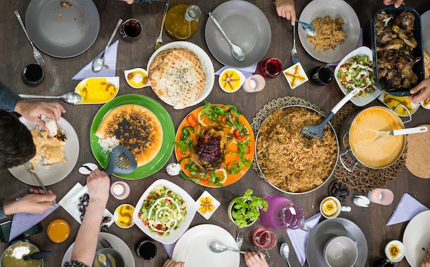 Draufsicht der familie und der freunde, die lebensmittel auf tabelle essen