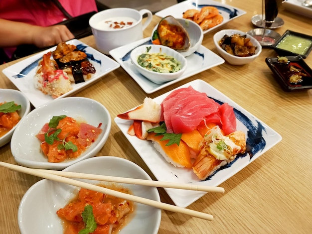 Draufsicht Japanische Sushi-Essensplattenkombination auf dem Holztisch