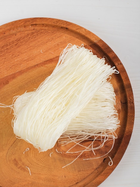 Draufsicht Rohe Reisnudeln, rohe Vermicelli-Nudeln in der Küche bereit zum Kochen. Isoliert auf Weiß