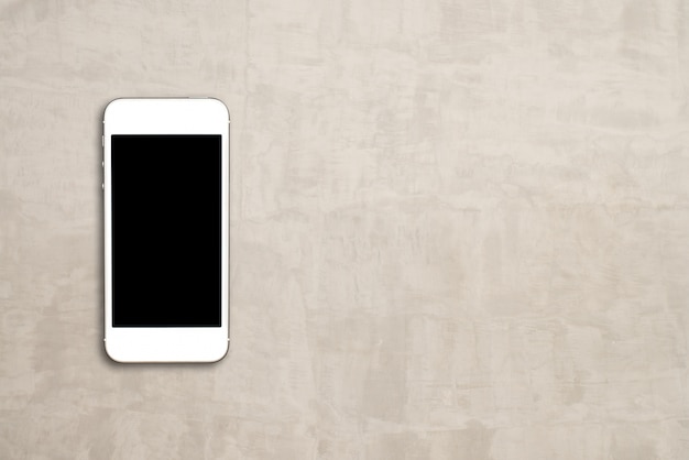 Draufsicht-Smartphone-Spott herauf Schablone mit schwarzem Schirm auf Zementtabelle mit copyspace.