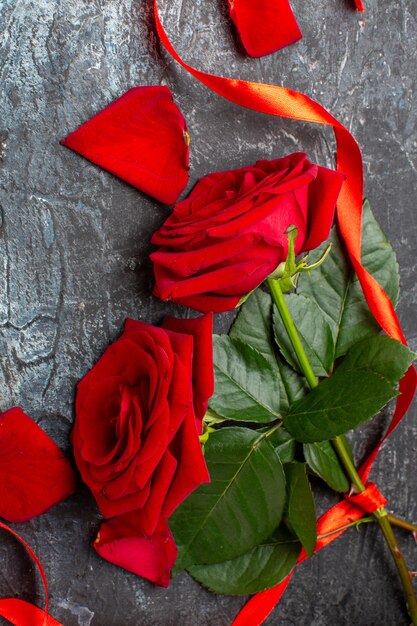Draufsicht Valentinstag Geschenk mit roten Rosen und Hinweis auf grauem Hintergrund Paar Ehe Liebe Urlaub Gefühl Herz