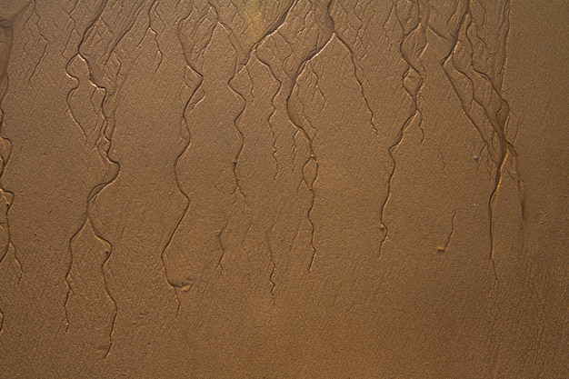 Draufsicht von strukturierten Linien Hintergrund auf Sand im Strand geschaffen durch die Ebbe.