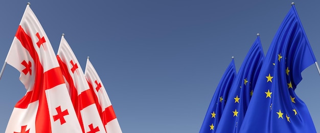 Drei Flaggen der Europäischen Union und Georgiens an Fahnenmasten an den Seiten Flaggen auf blauem Hintergrund Platz für Text EU Europa Tiflis Commonwealth 3D-Darstellung