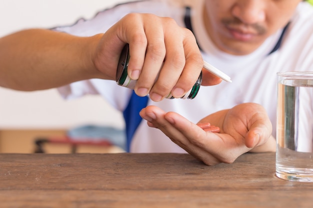 Drogas en la mano paciente, colorido de comer medicamentos, drogas o píldoras concepto de atención médica