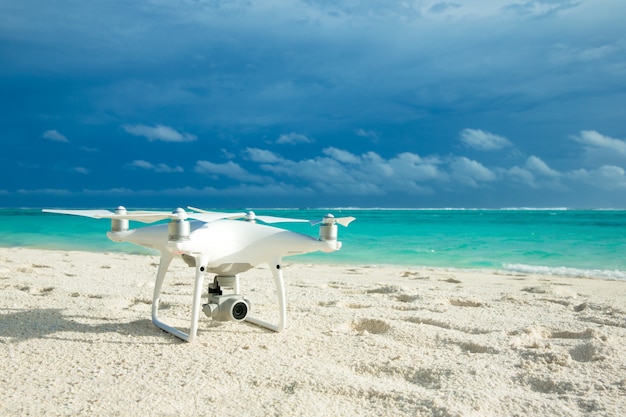 Drohnen-Hubschrauber, der über tropischem Strand fliegt