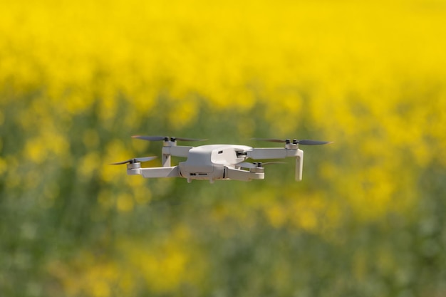 Dron de inspección en un campo de colza en flor