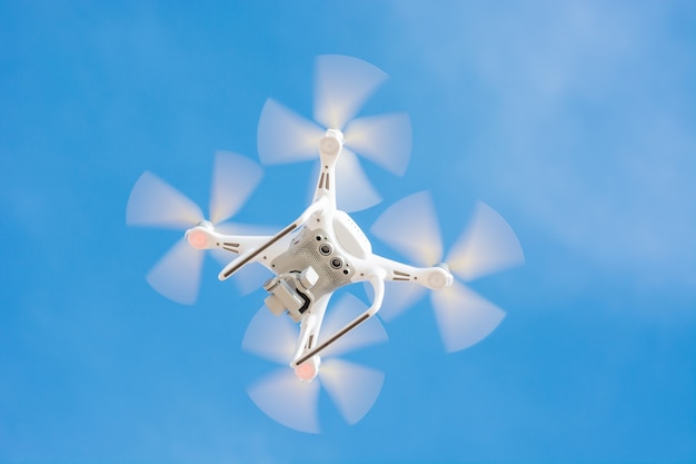 Drone Of White Color Flying En El Cielo Azul, Concept Video Technology.