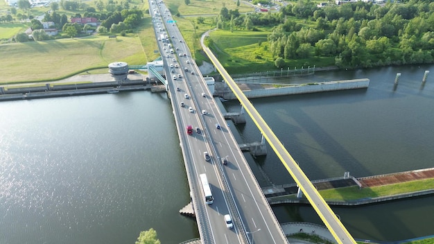 Drone shot of busy river crossing bridge