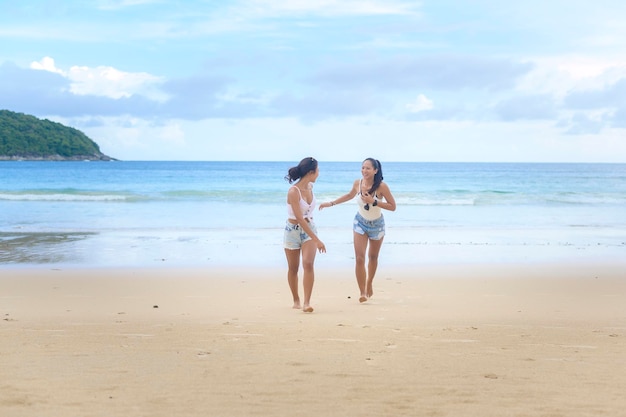 Duas amigas atraentes desfrutando e relaxando nas férias de verão da praia