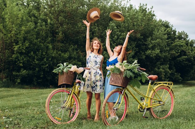 Duas amigas com bicicletas retrô são relaxantes na natureza