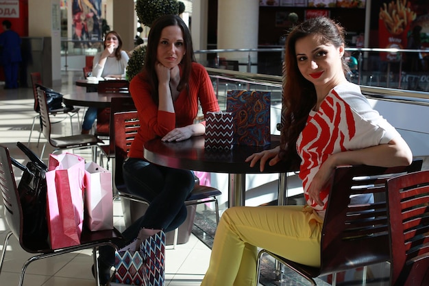 Duas garotas lindas vão às compras no shopping