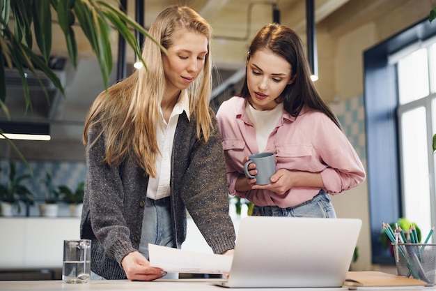 Duas jovens trabalhando juntas no escritório