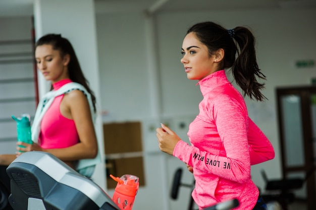 Duas meninas correndo na esteira