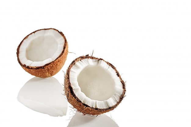 Duas metades de coco em uma superfície branca