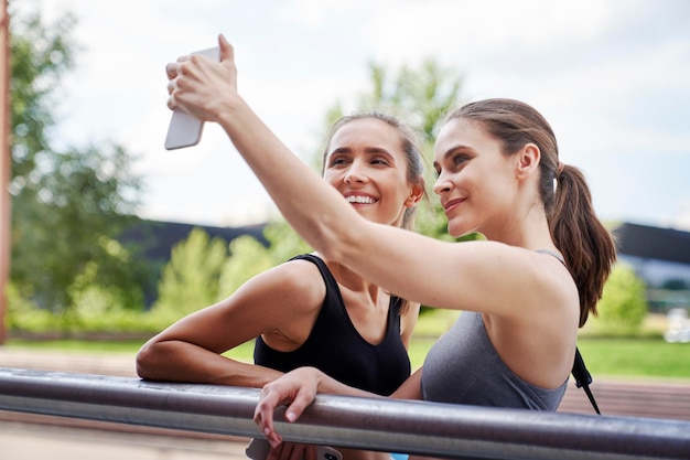 Duas mulheres atléticas a tirar uma selfie.