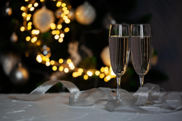 Duas taças de champanhe sobre manchas de desfoque fundo de luzes Conceito de feriado de celebração espaço livre para texto