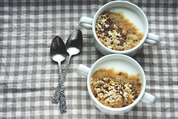 Duas tigelas com farelo de iogurte branco e sementes